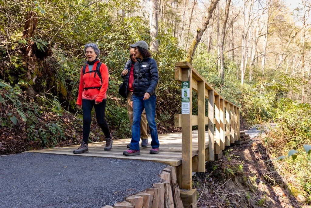 Hikers walking on a newly constructed trail bridge on the Estatoe trail